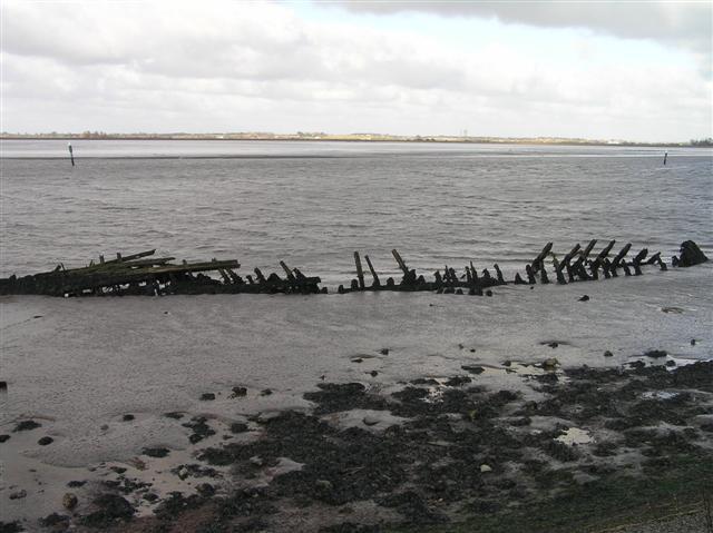 Saltmarsh and Intertidal Flats + Breydon Water showing remains of old wherry in foreground. (© L Marsden / A Yardy)